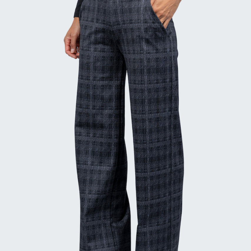Plaid pants worn by a person on a gray background