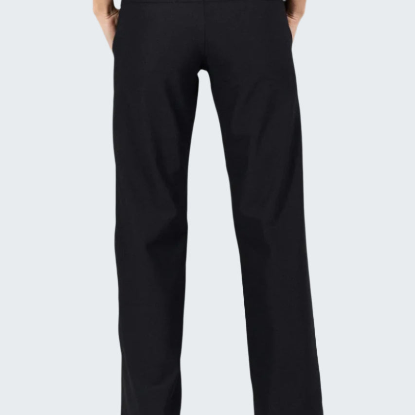 Black pants worn by a person on a gray background