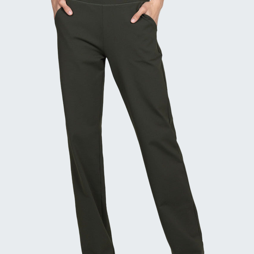 Dark gray pants worn with a green top on a light gray background