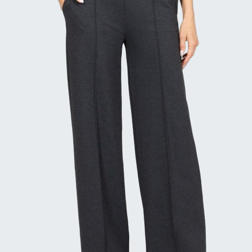 Dark gray wide-leg pants worn by a person on a white background