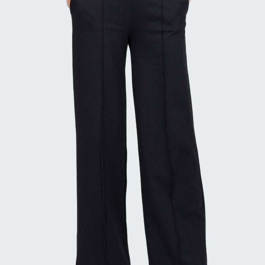 Person wearing black high-waisted pants on a white background