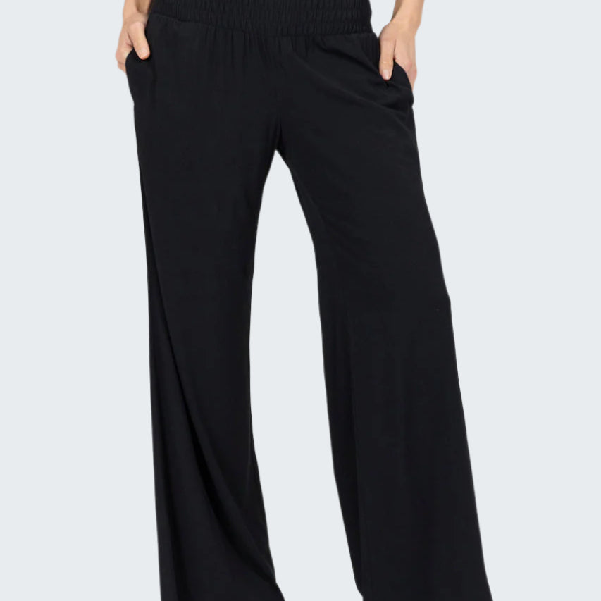 Black wide-leg pants worn by a person on a white background