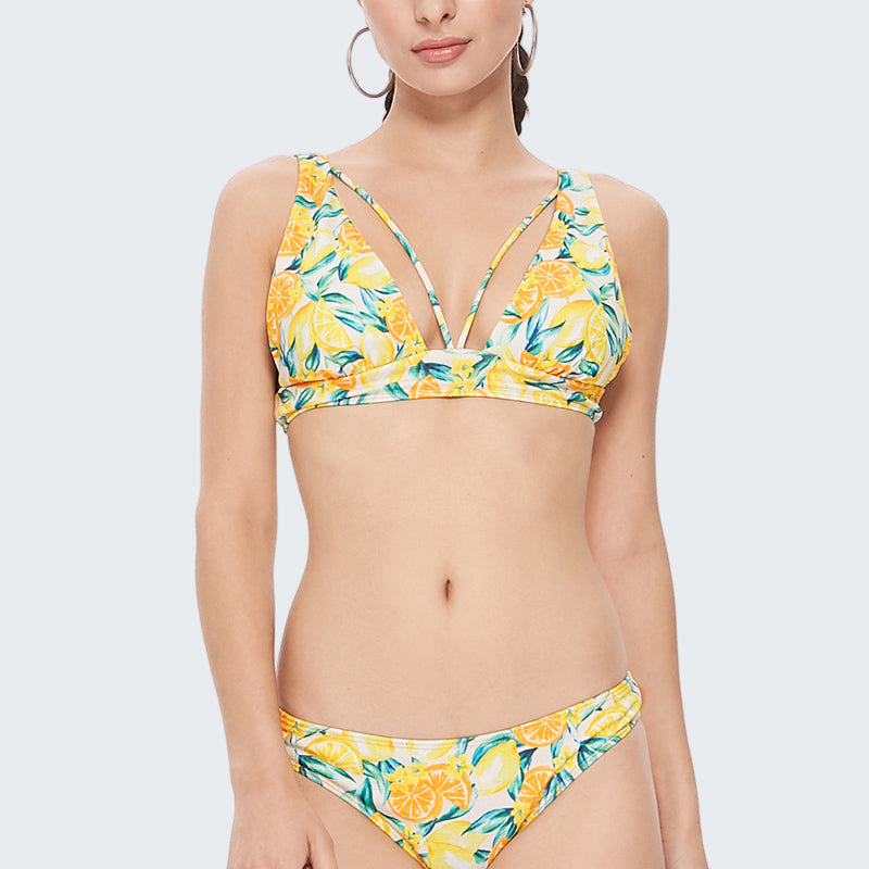 Woman wearing a yellow floral bikini on a white background