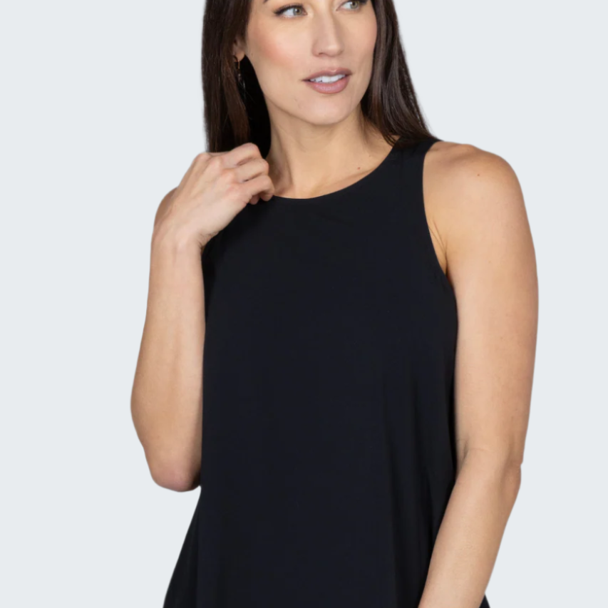 Woman wearing a black sleeveless top against a gray background