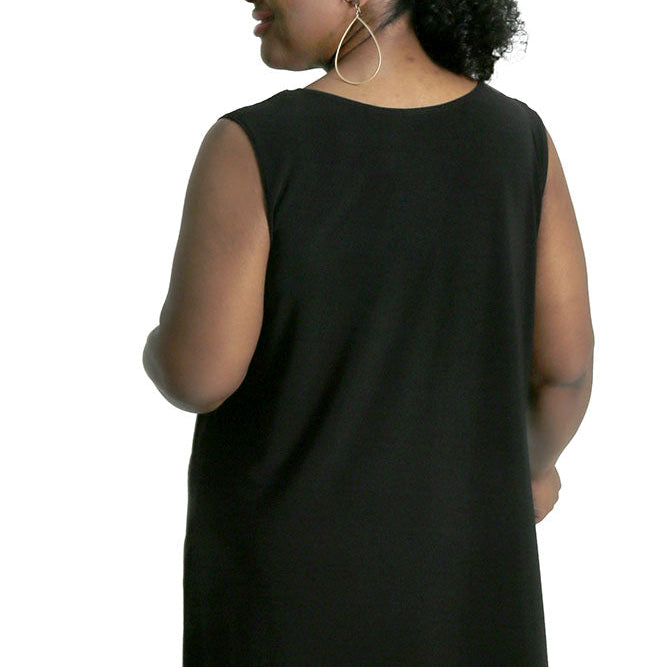 Person wearing a black sleeveless top on a white background
