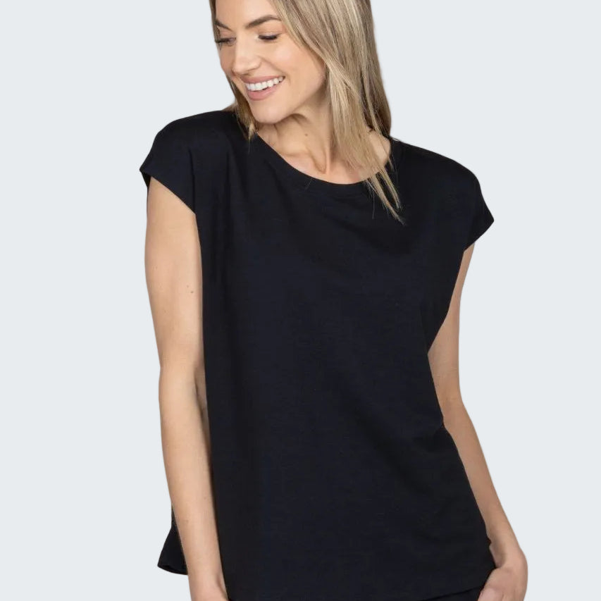 Woman wearing a black sleeveless top against a beige background