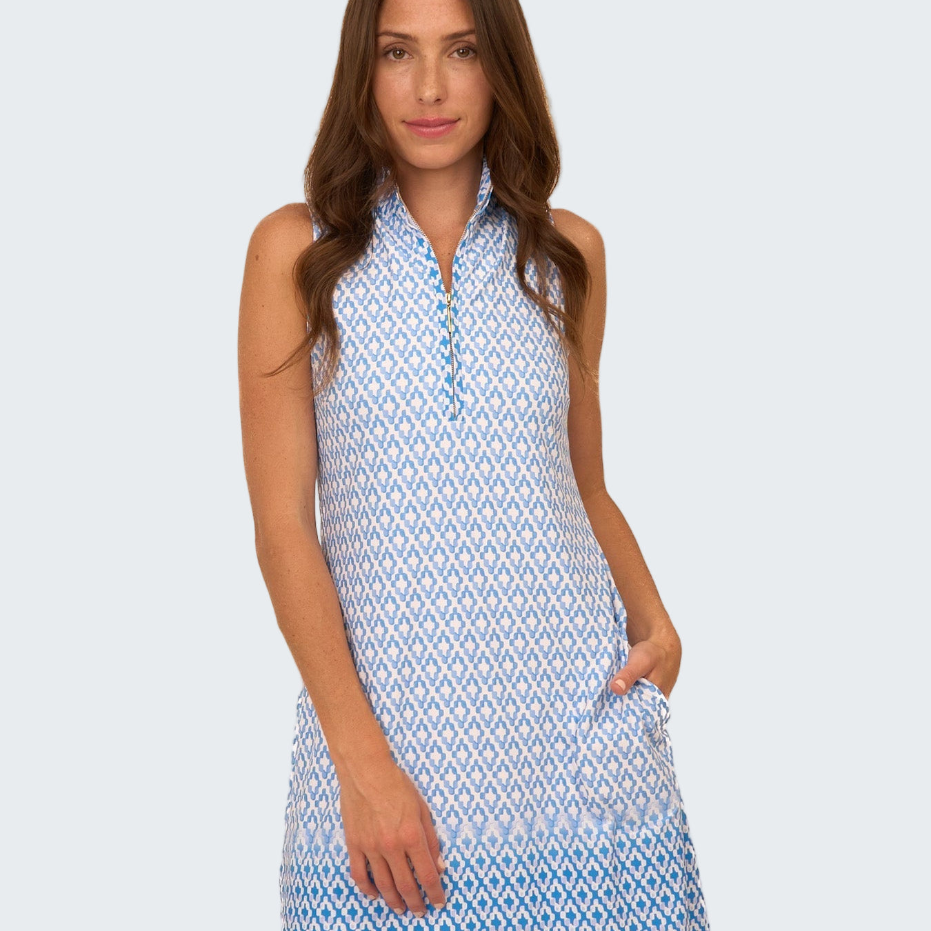 Woman wearing a blue and white patterned dress on a white background