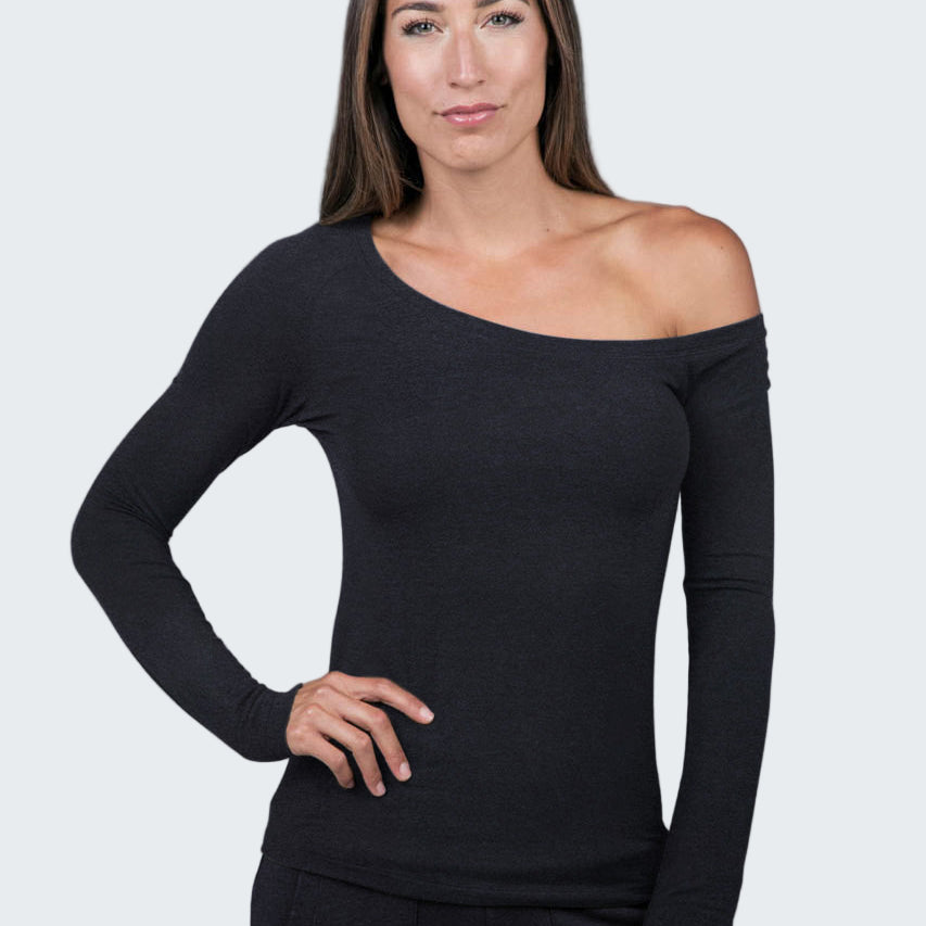Woman wearing a black off-shoulder top against a gray background