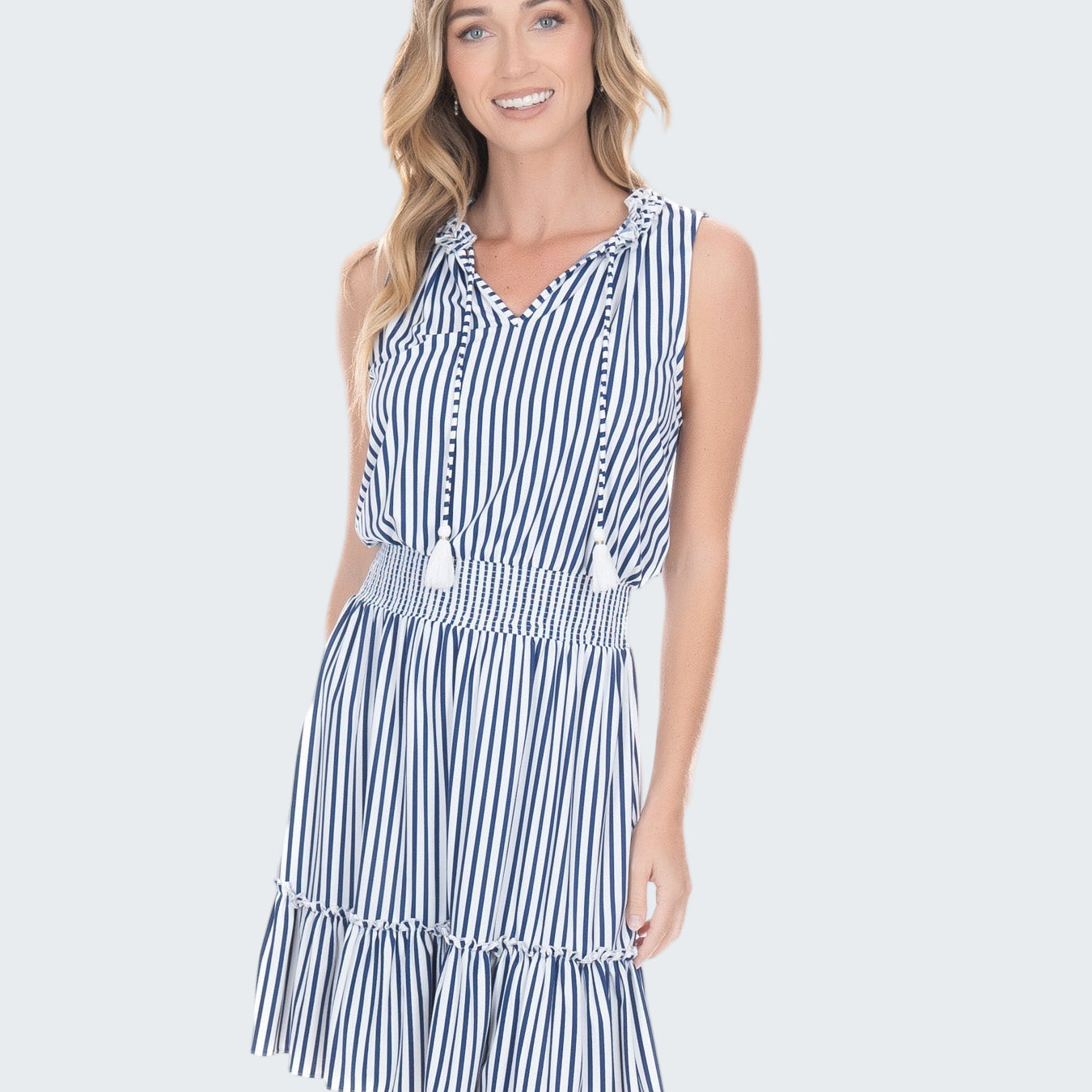 Woman wearing a blue and white striped dress on a white background