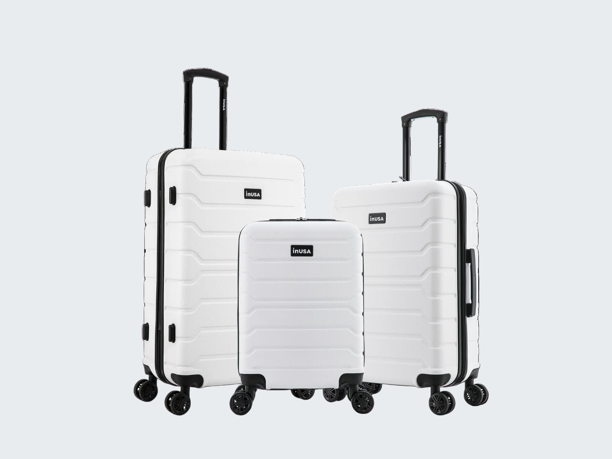Set of three white suitcases with black handles and wheels on a white background