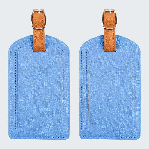 Two blue luggage tags with brown straps on a white background