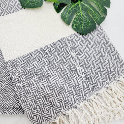Textile with geometric pattern and fringes on a white background