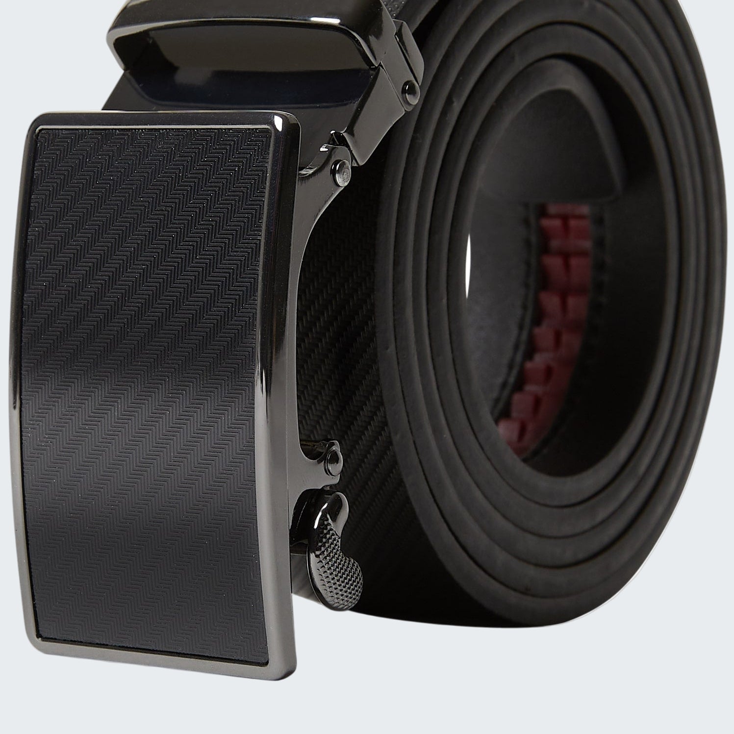 Black belt with a carbon fiber pattern buckle on a white background