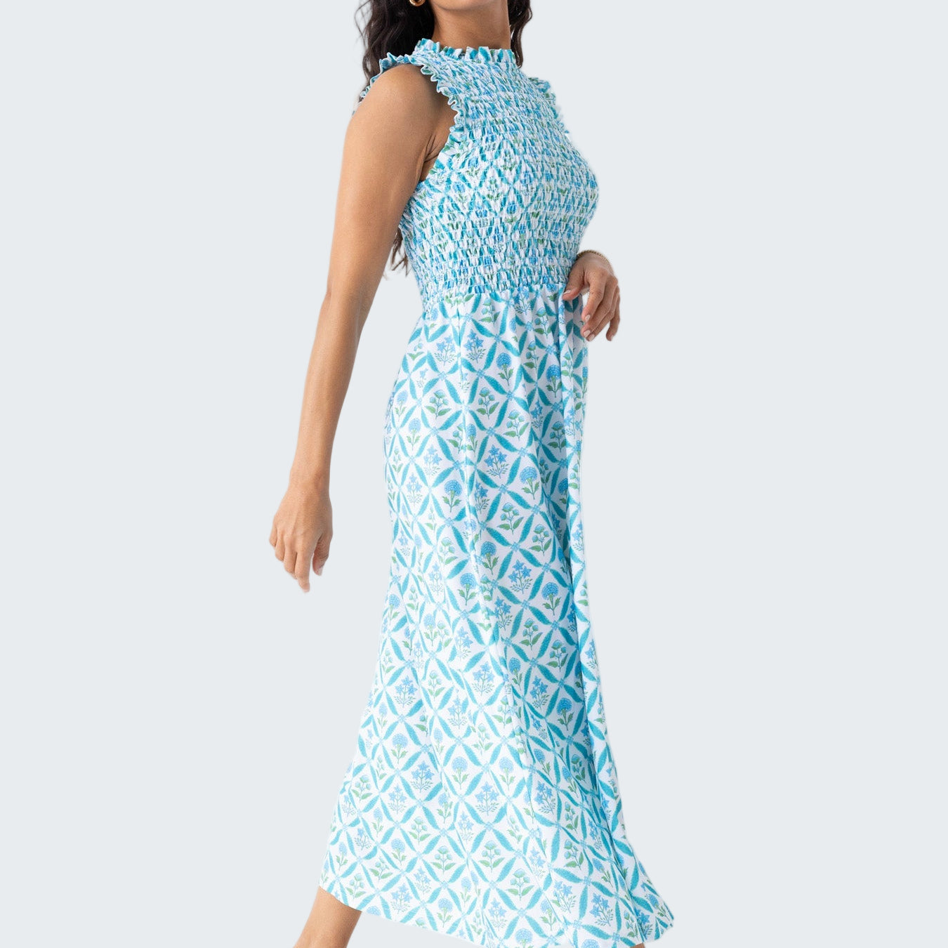 Woman wearing a blue patterned dress against a white background