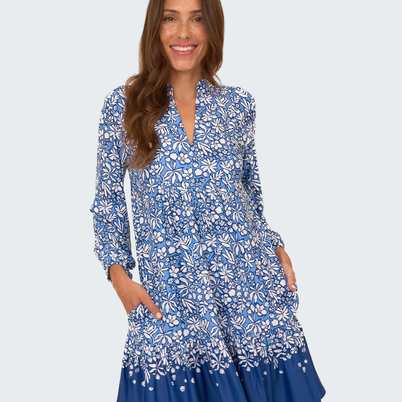 Woman wearing a blue floral dress on a white background