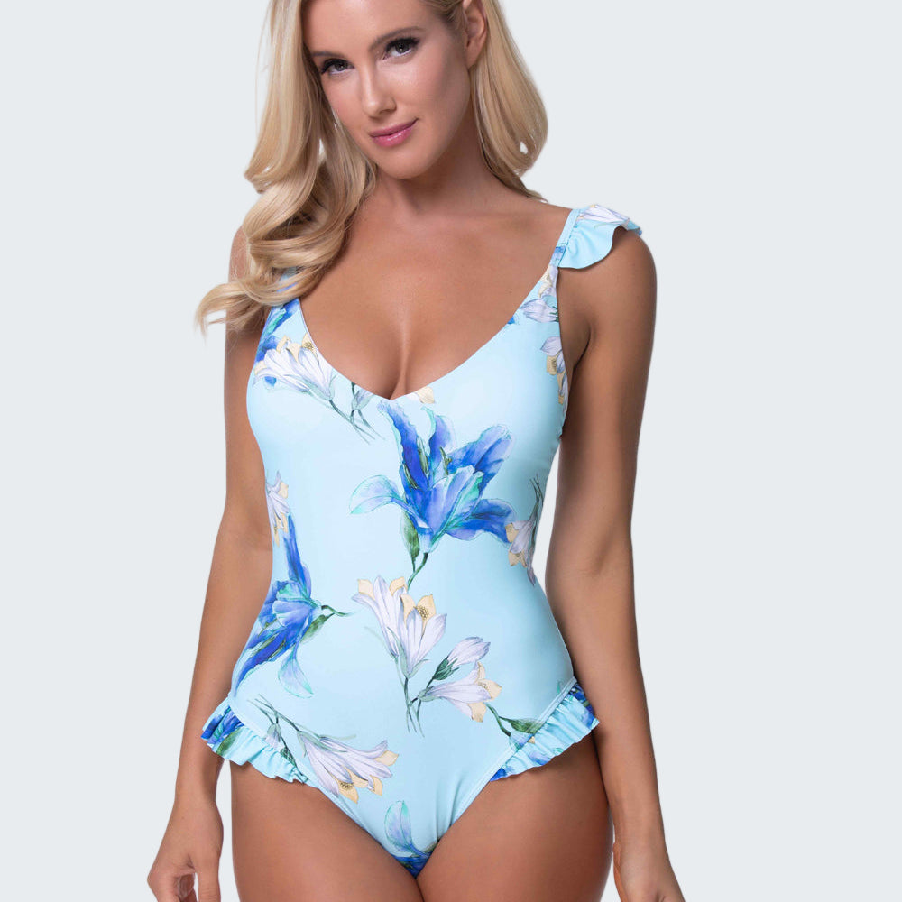 Woman wearing a blue floral one-piece swimsuit on a white background