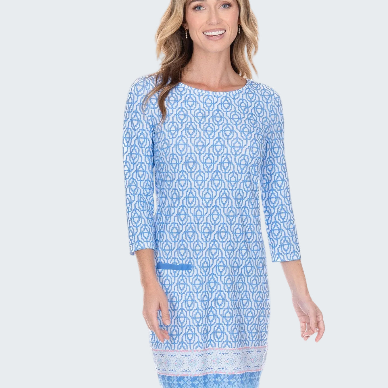 Woman wearing a blue patterned dress on a white background