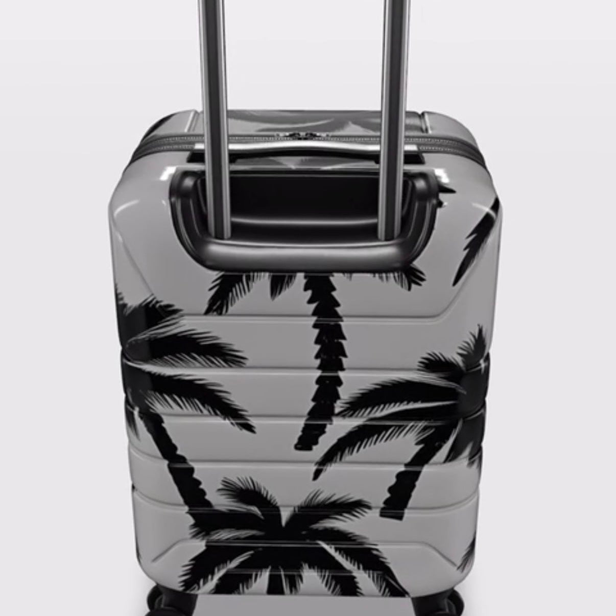 Suitcase with palm tree design on a white background