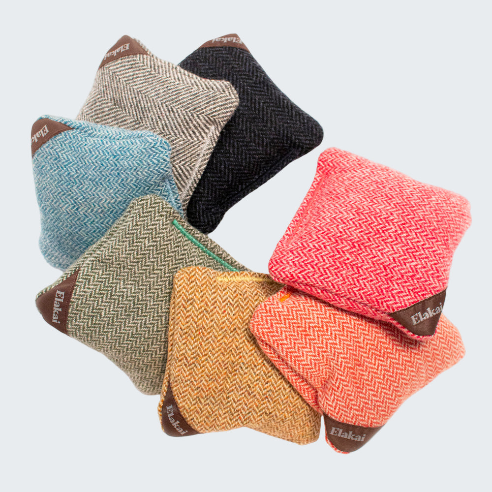 Set of colorful fabric pouches with herringbone pattern on a white background