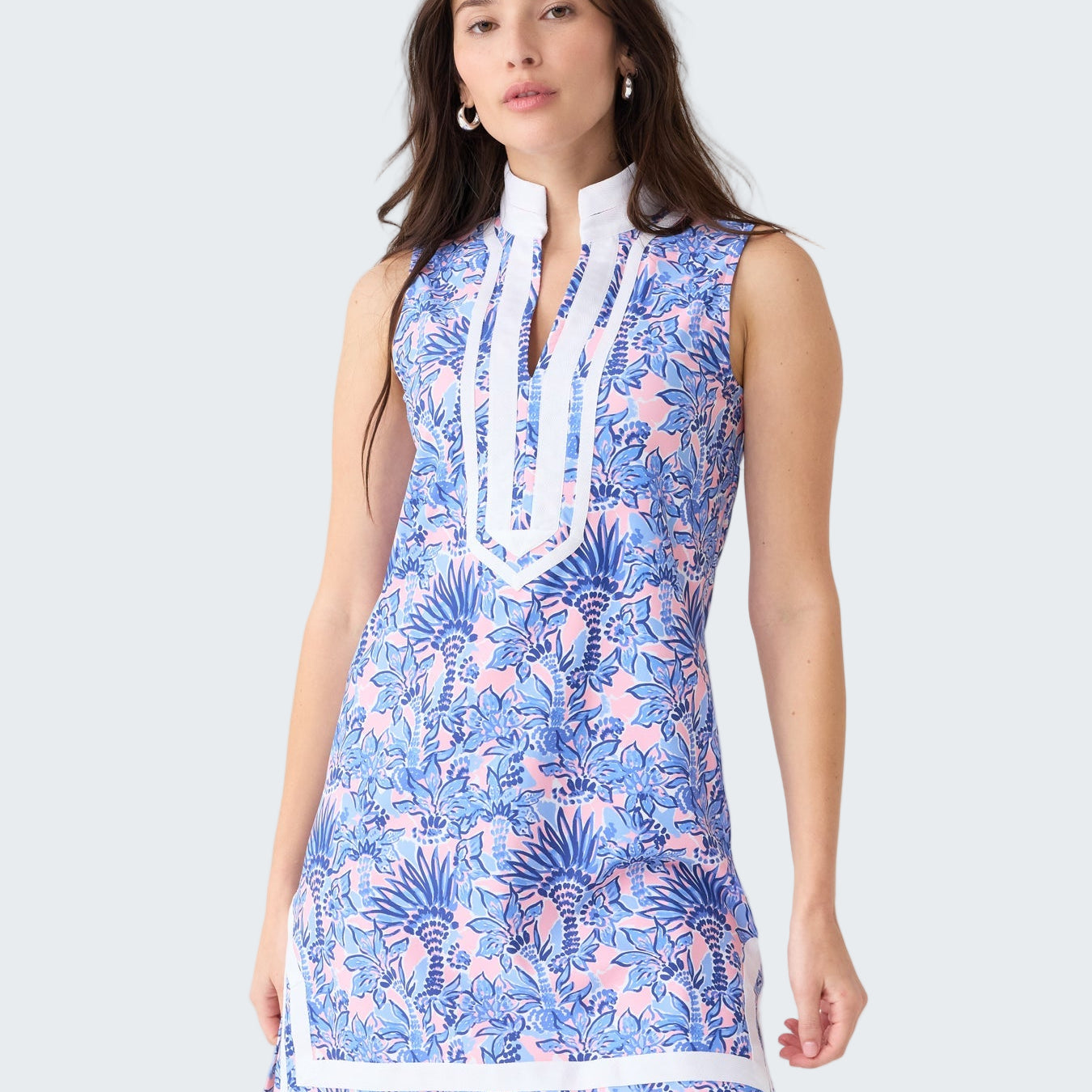 Woman wearing a blue floral dress on a white background