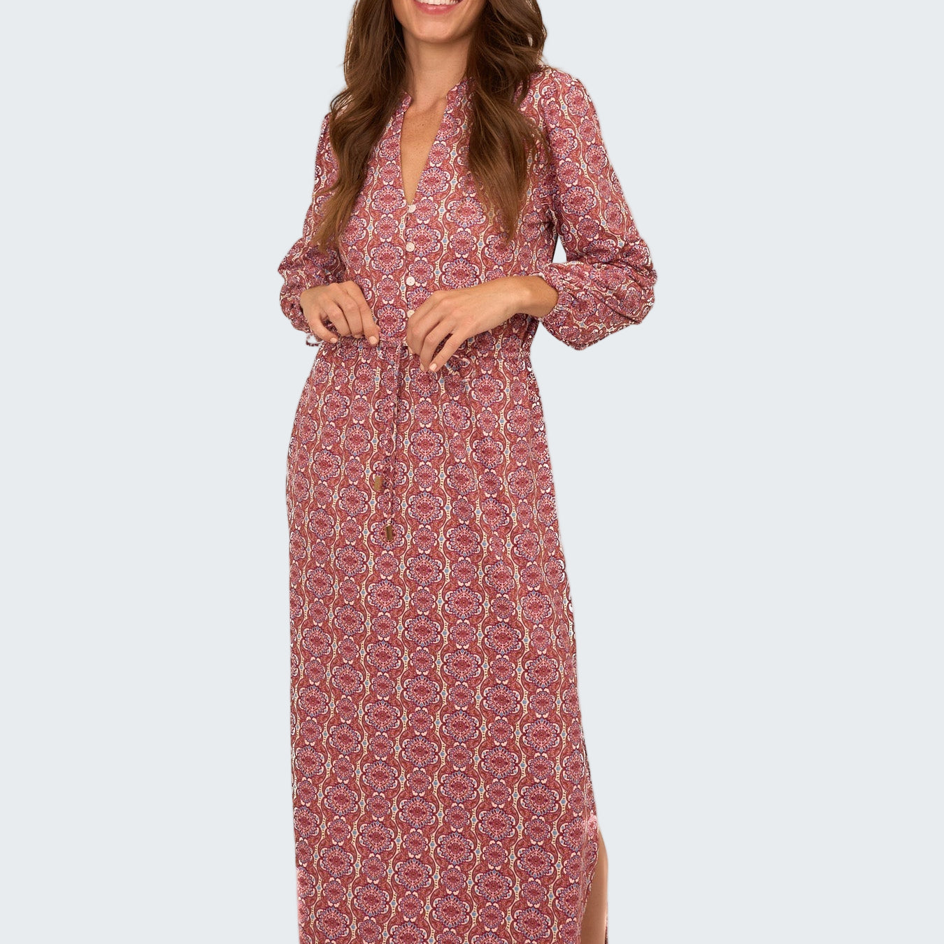 Woman wearing a red patterned dress on a white background