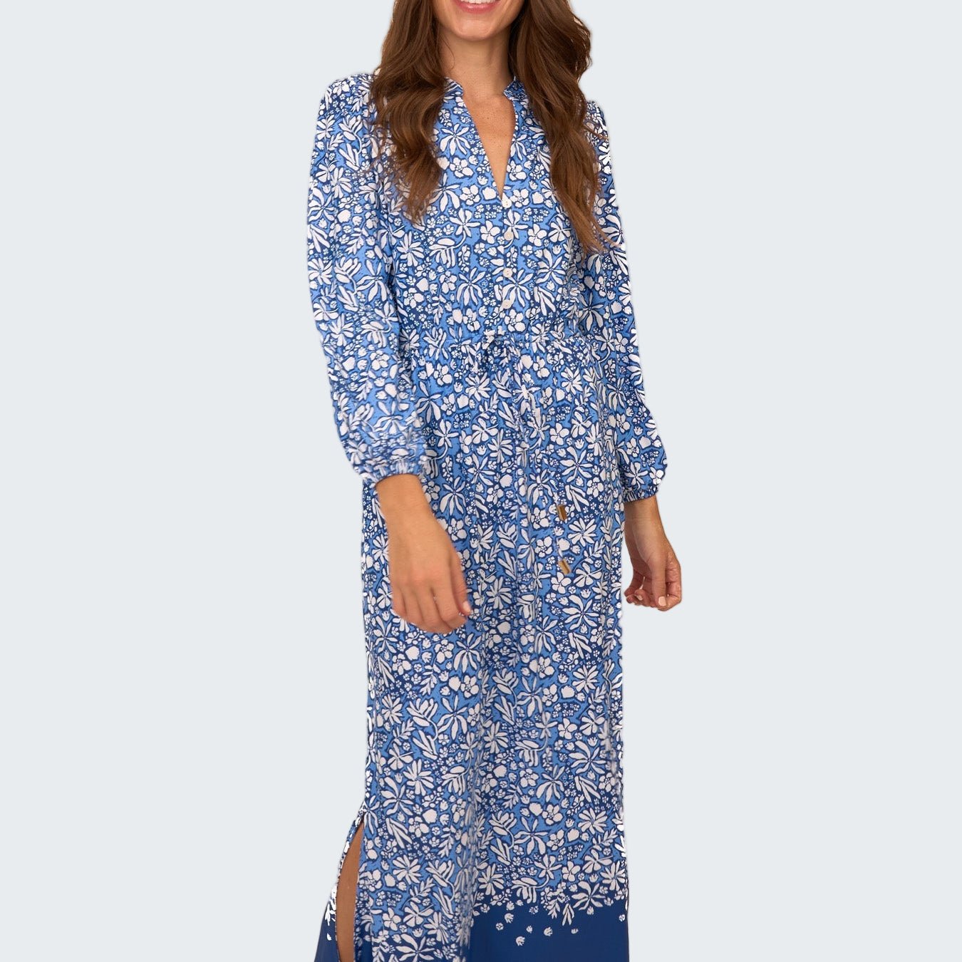 Woman wearing a blue floral dress on a white background