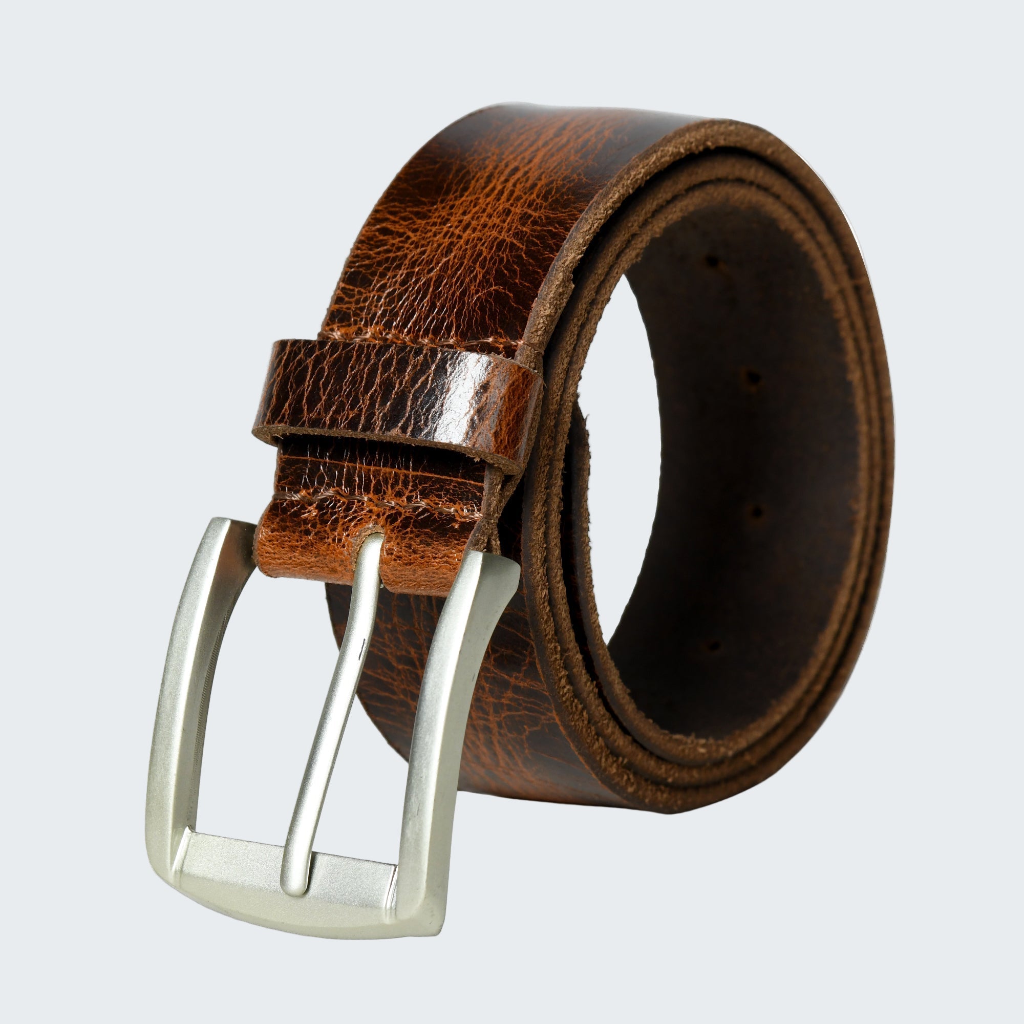 Brown leather belt with a silver buckle on a white background