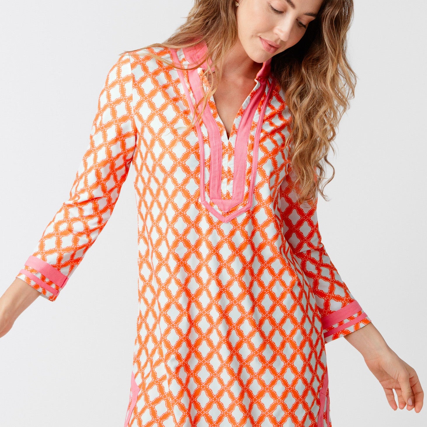 Woman wearing a colorful patterned dress on a white background