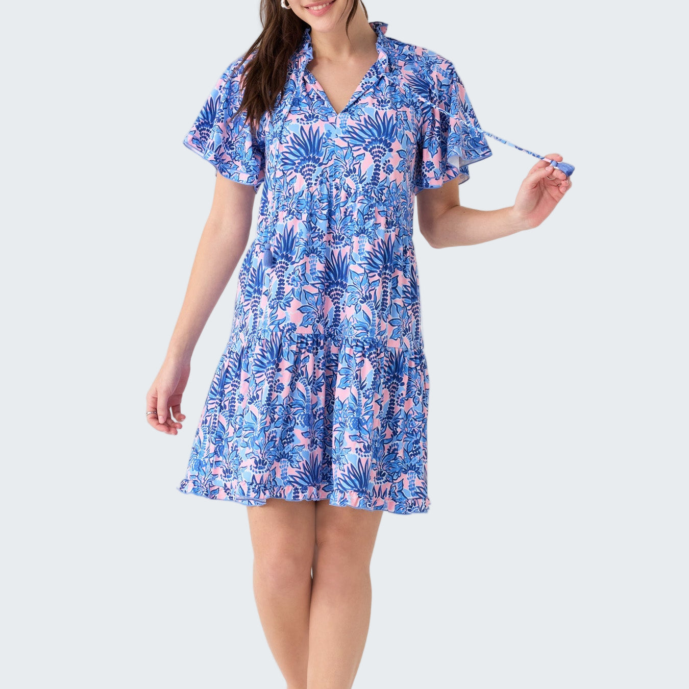 Woman wearing a blue floral dress on a white background