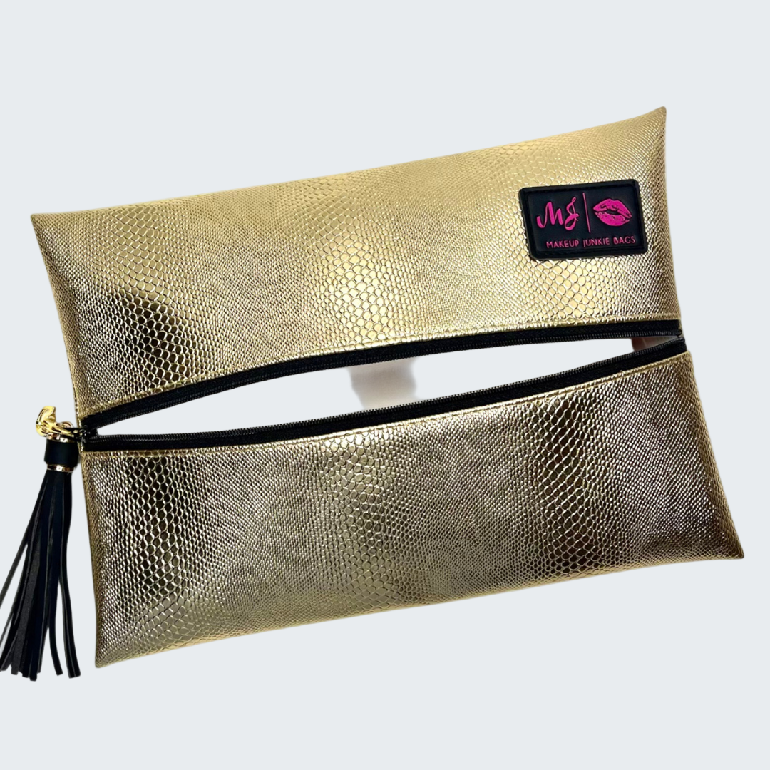 Gold makeup bag with a visible brand logo on a white background
