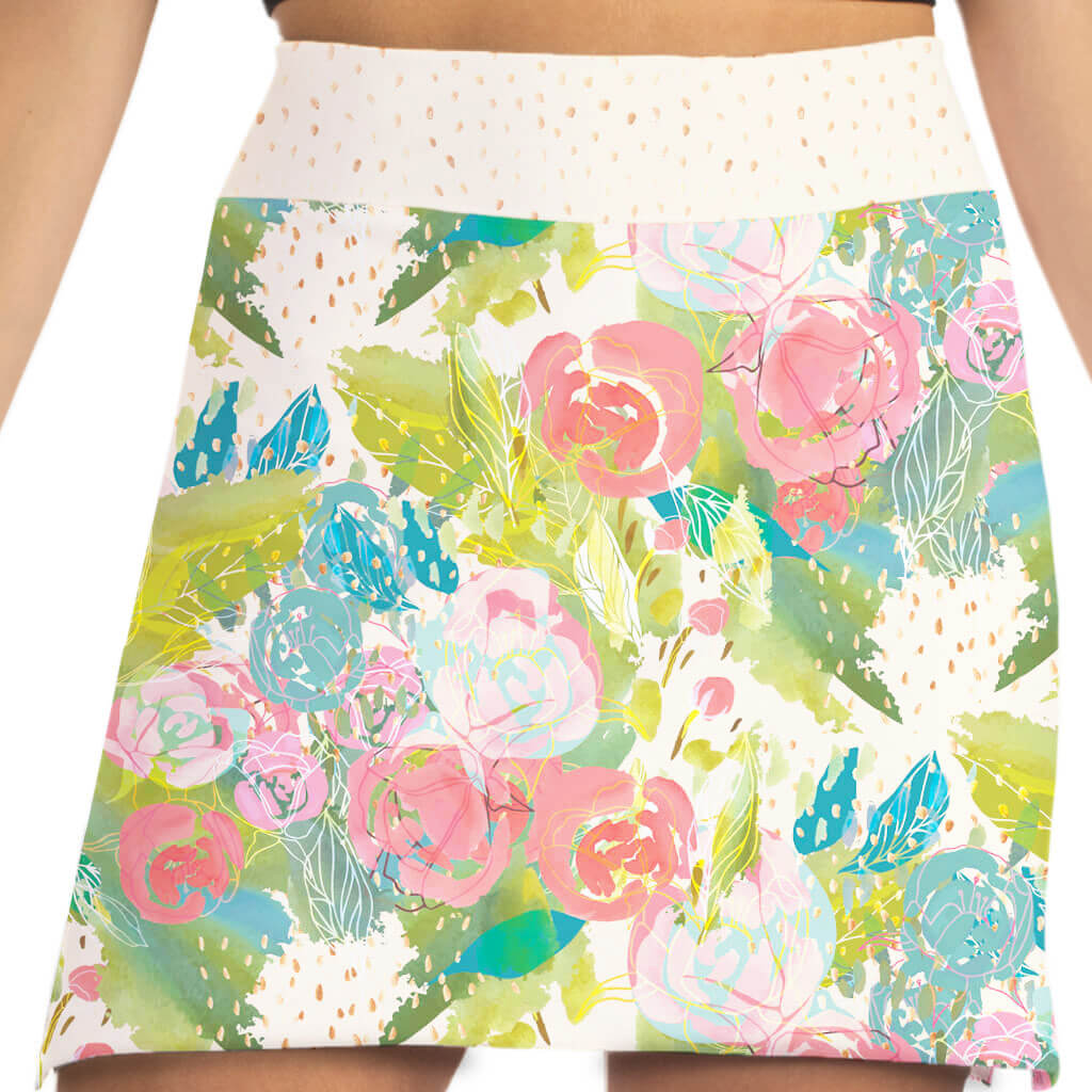 Floral patterned skirt with pink roses and green leaves on a white background