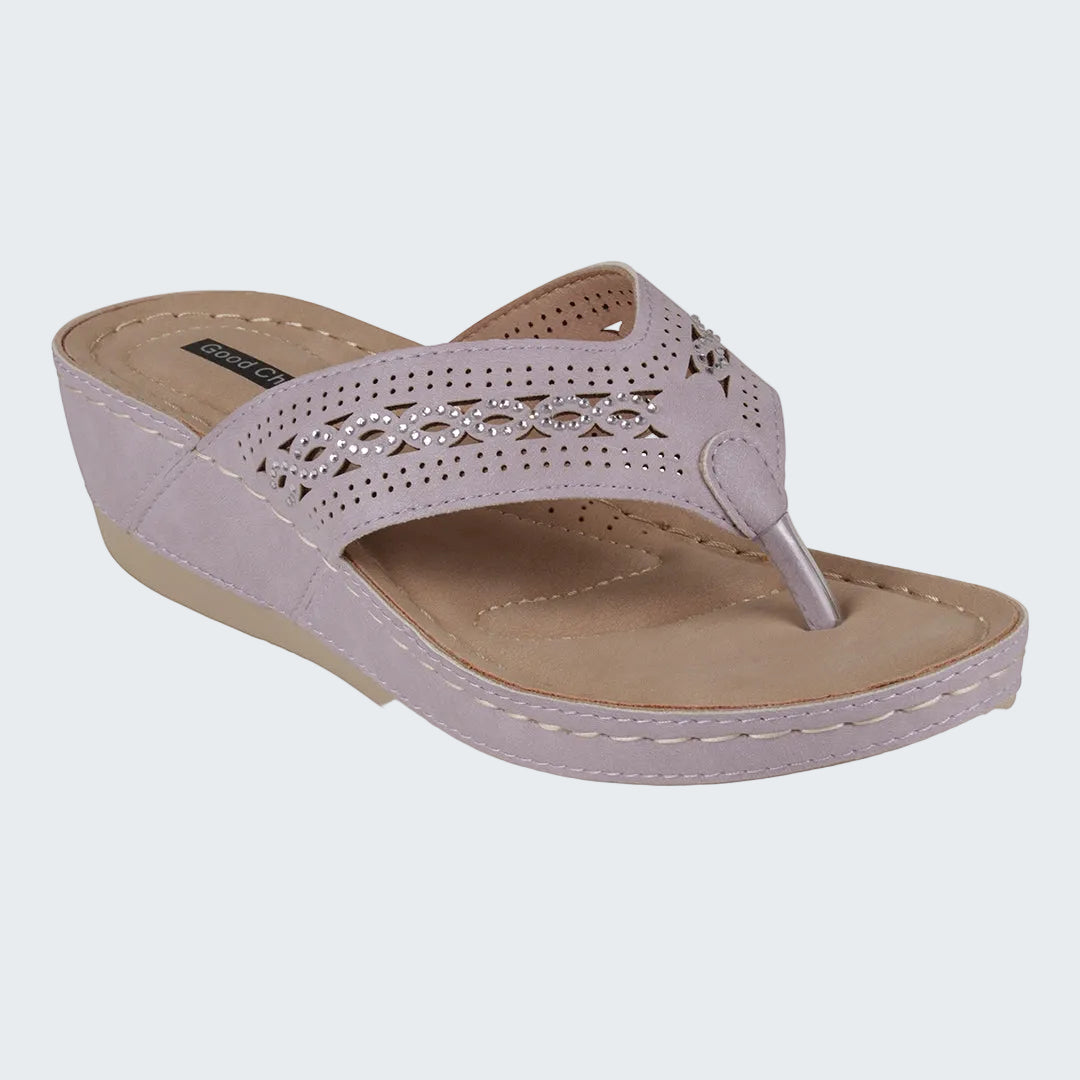 Pink sandal with a beige wedge sole on a white background