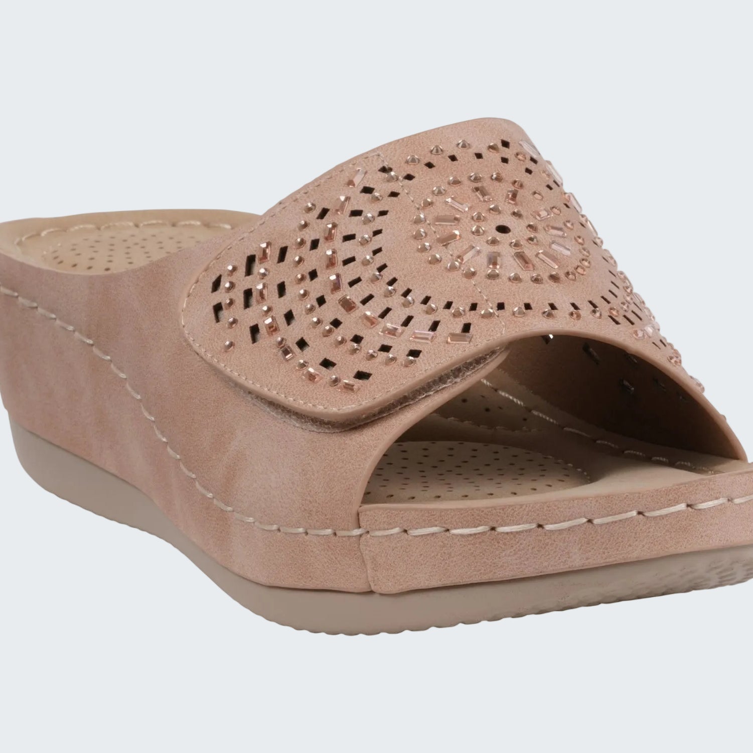 Beige sandal with cut-out design on a white background