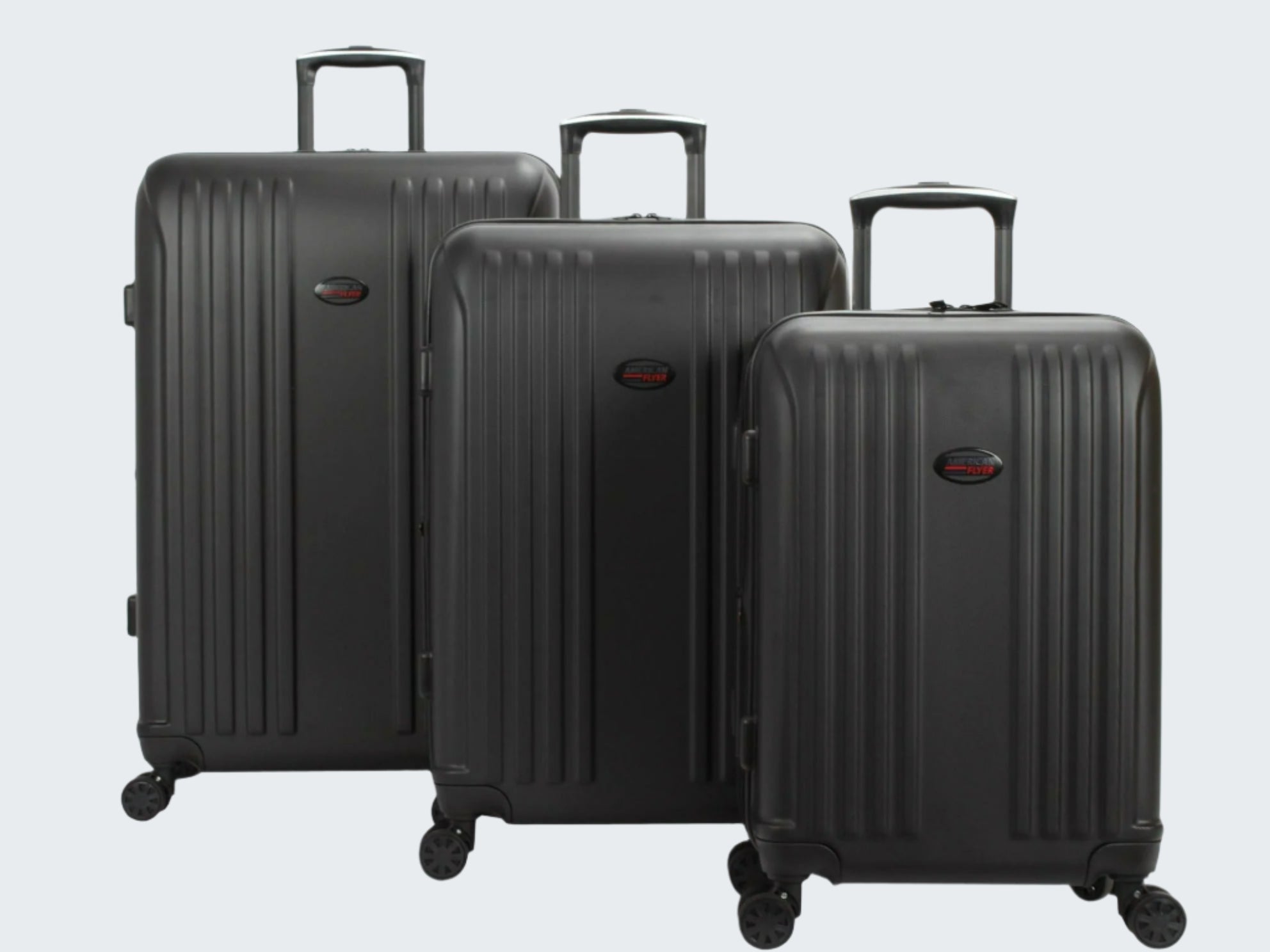 Three black suitcases of different sizes on a white background