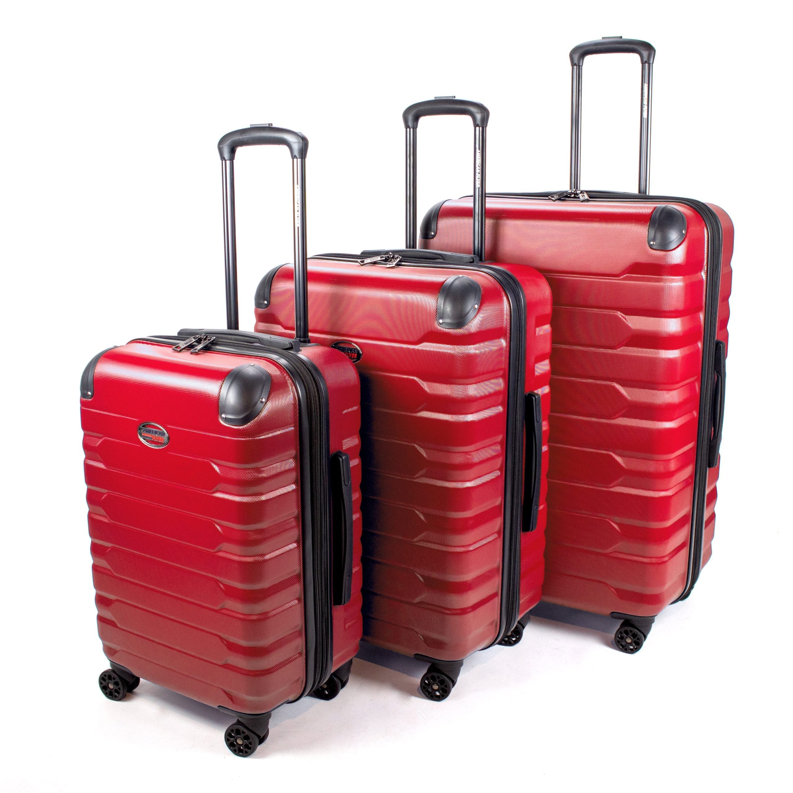 Set of red suitcases with black handles and wheels on a white background