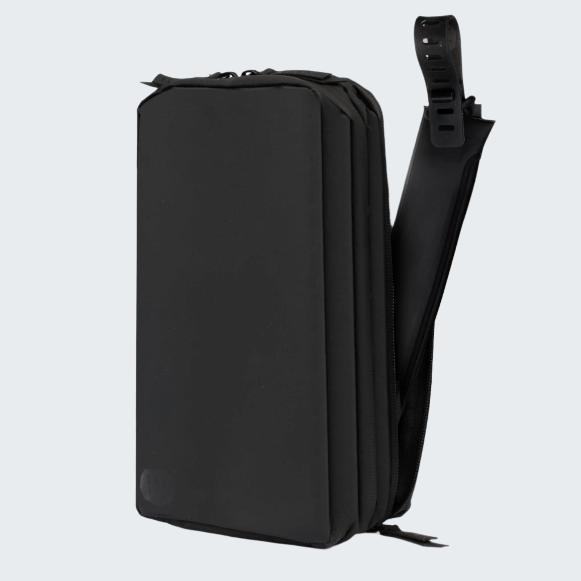 Black backpack with a shoulder strap on a white background