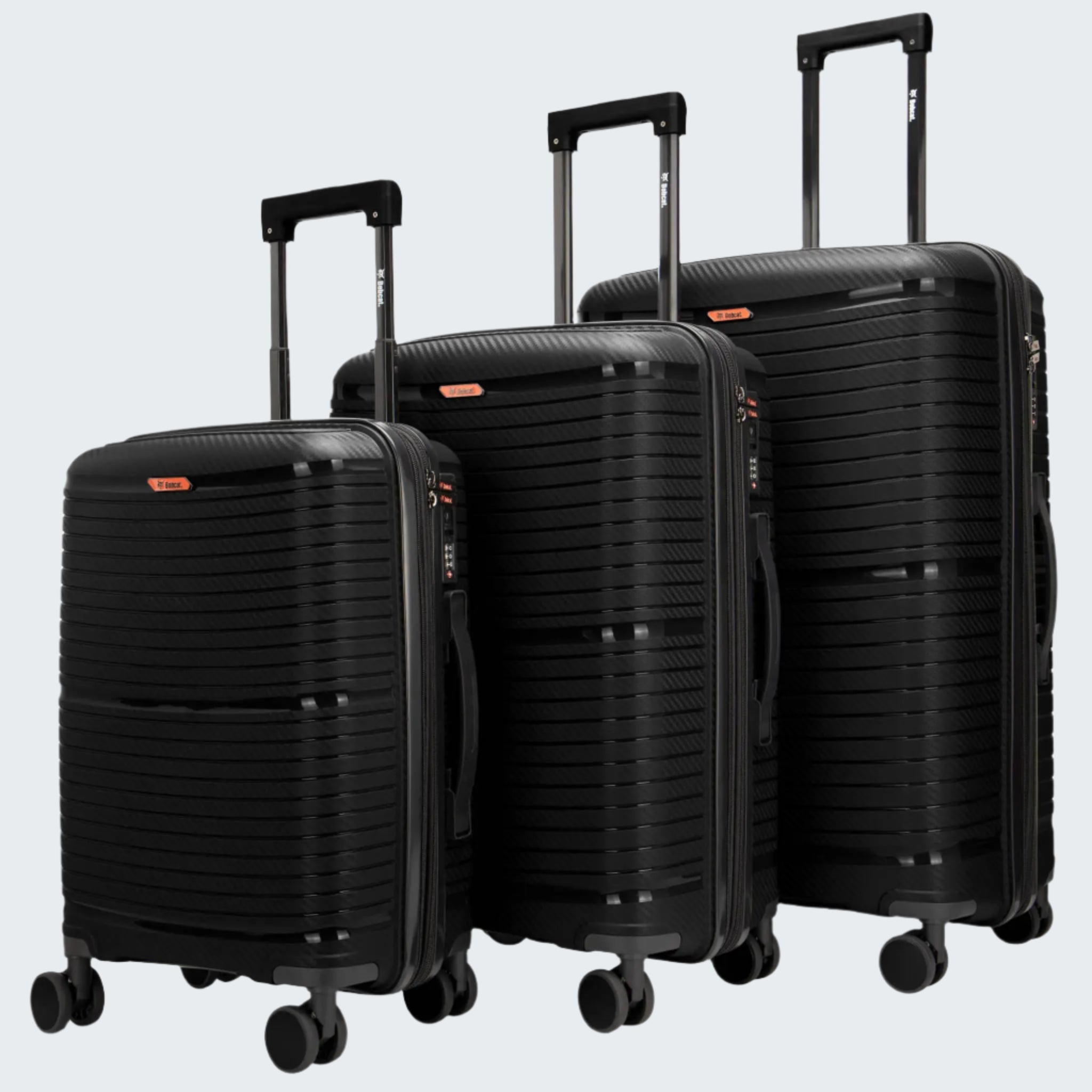 A set of three black Bobcat Trencher suitcases with carbon fiber texture, including a carry-on, medium, and large size, with spinner wheels and trolley handles.