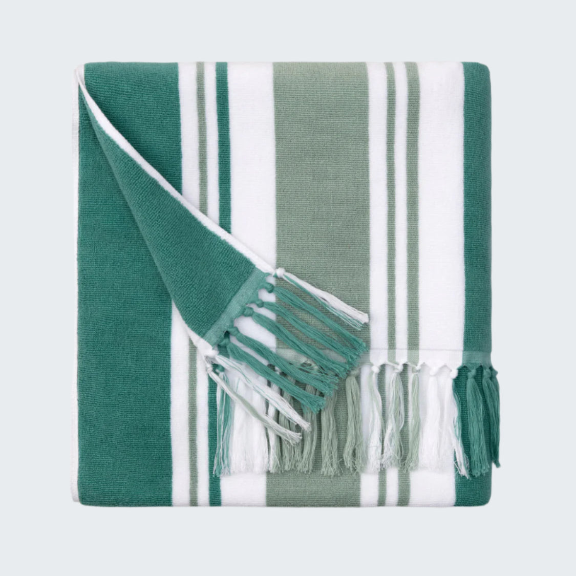 Green and white striped towel with fringes on a white background
