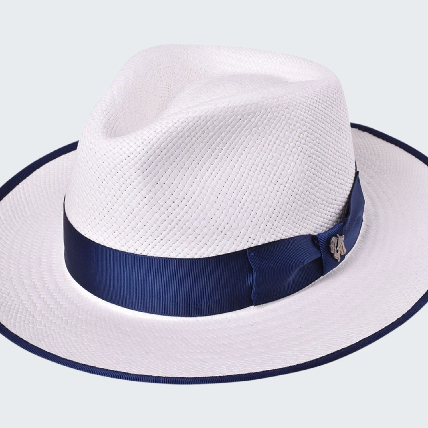 White straw hat with a navy blue band on a white background
