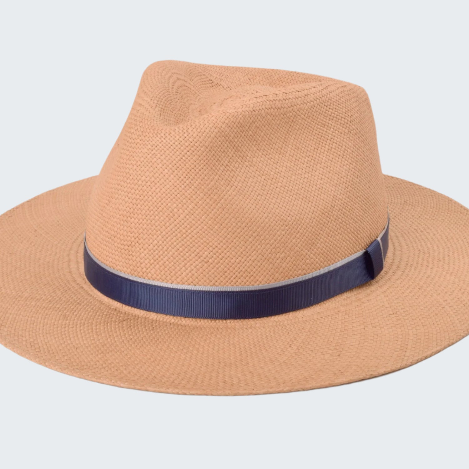 Beige straw hat with a navy band on a white background