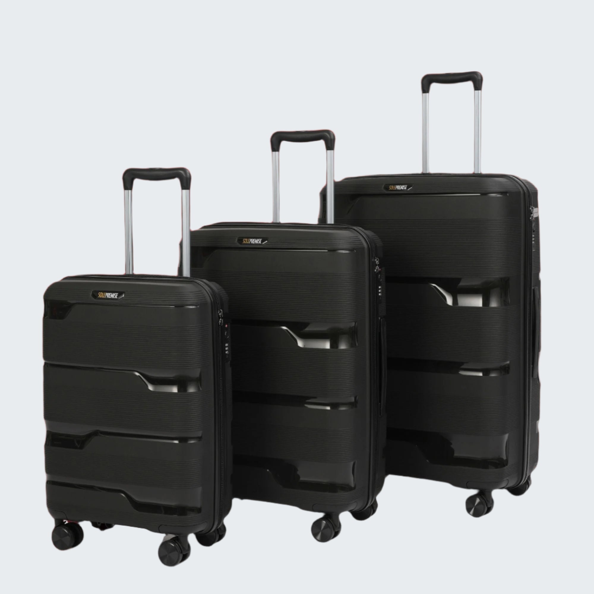 Three black suitcases of different sizes on a red background