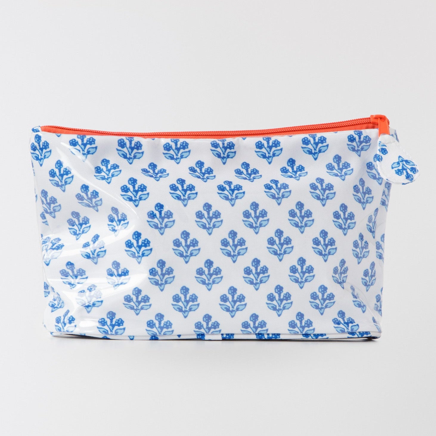 Pouch with blue floral pattern and red zipper on a white background
