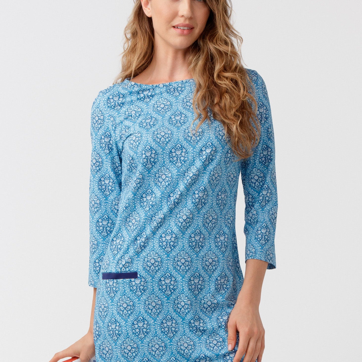 Woman wearing a blue patterned dress on a white background