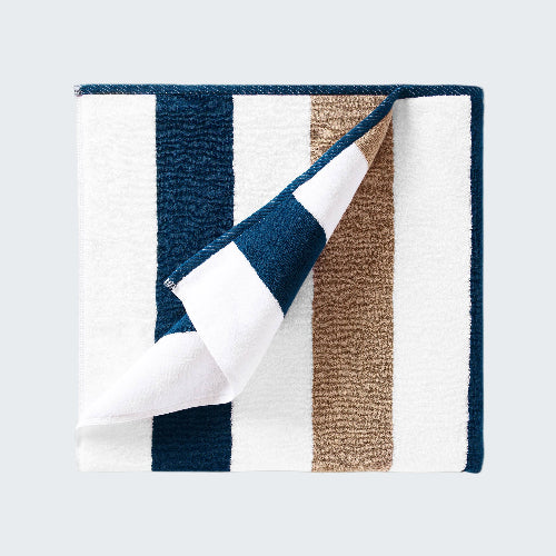 Folded fabric with blue, white, and brown stripes on a white background