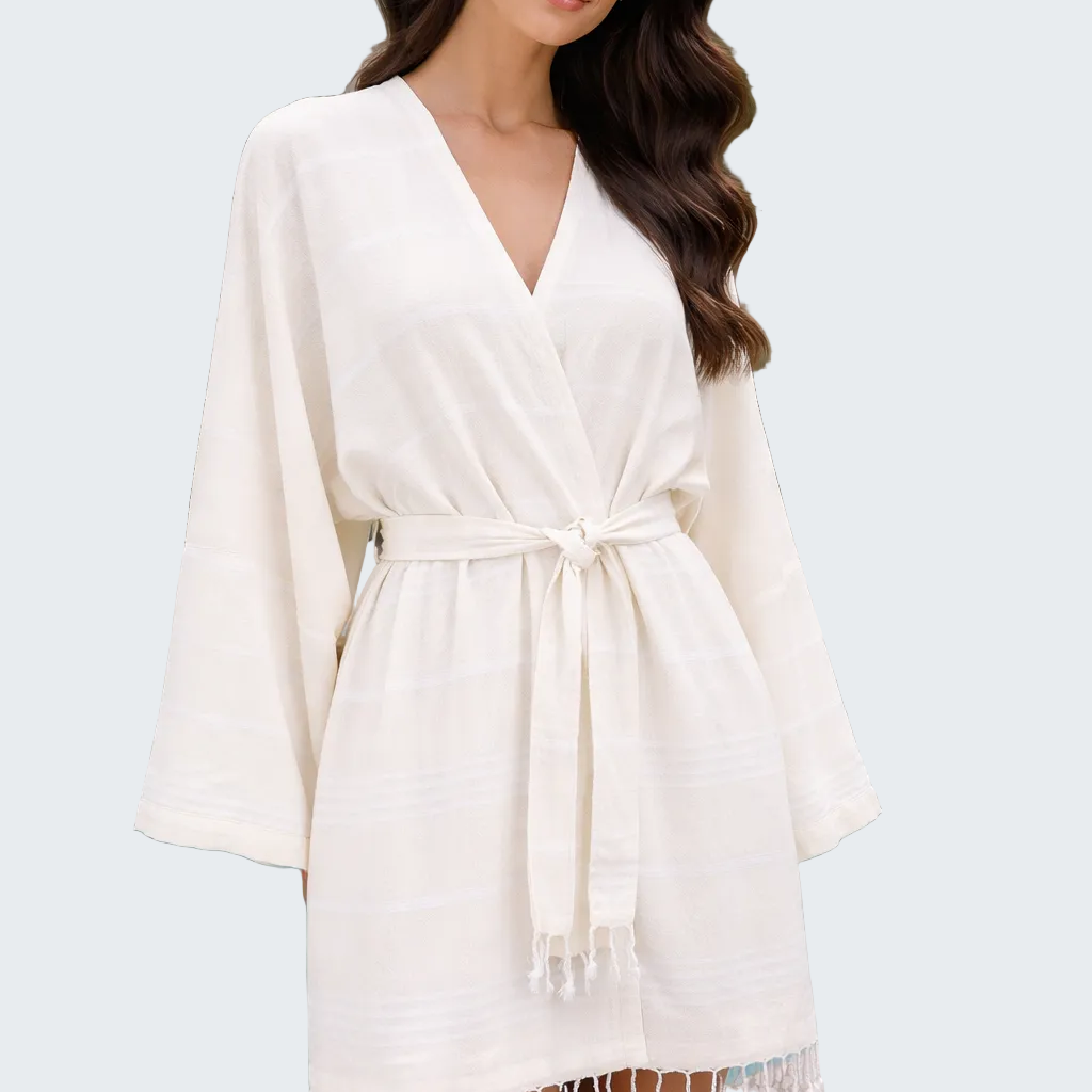 Woman wearing a white robe by a poolside