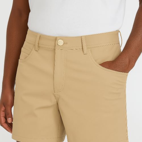 Person wearing beige shorts and a white shirt on a plain background