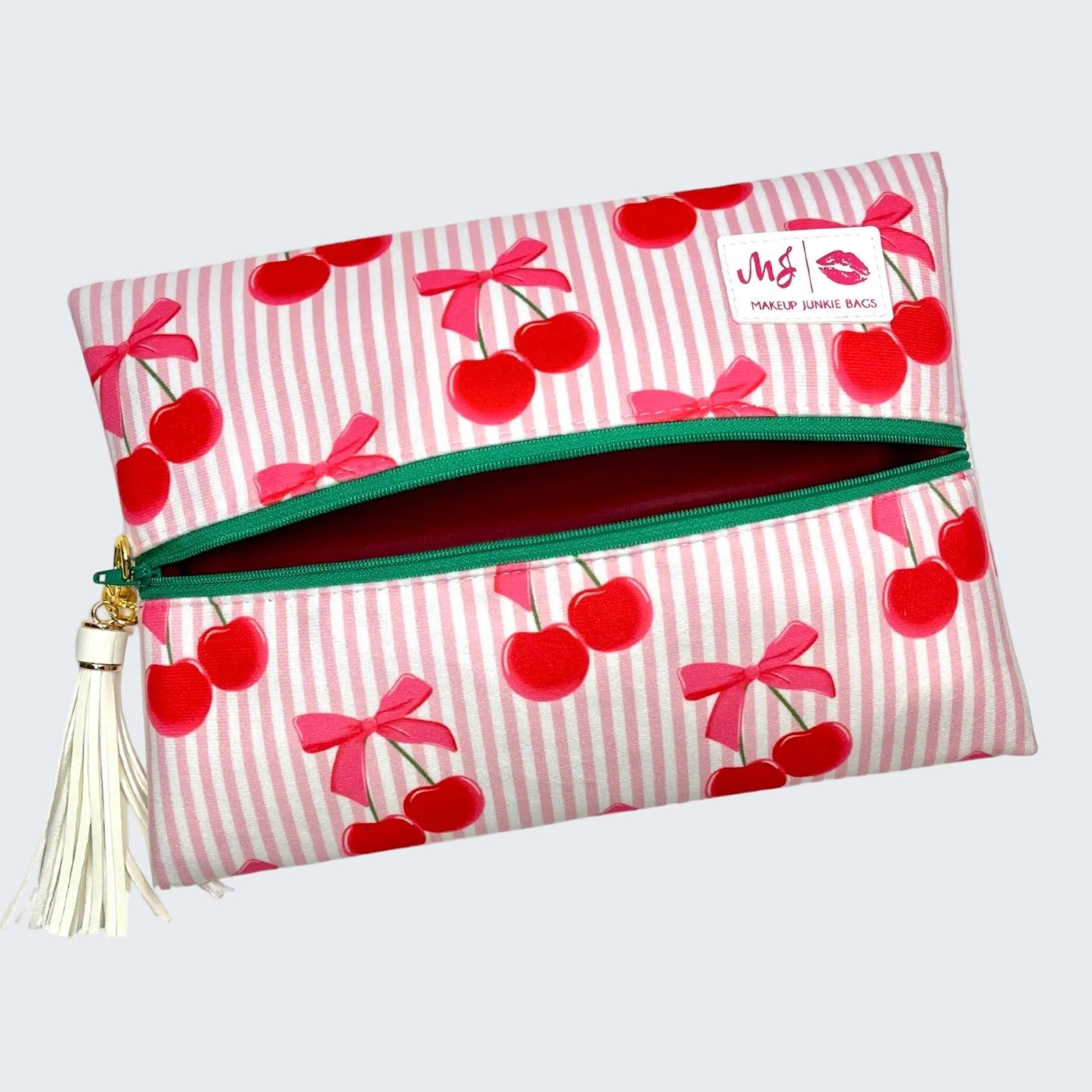 Makeup bag with cherry and bow pattern on a white background