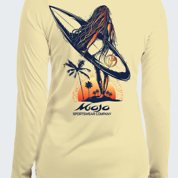 Beige long-sleeve shirt with a graphic of a woman on a surfboard and palm trees, featuring the Mojo Sportswear Company logo.