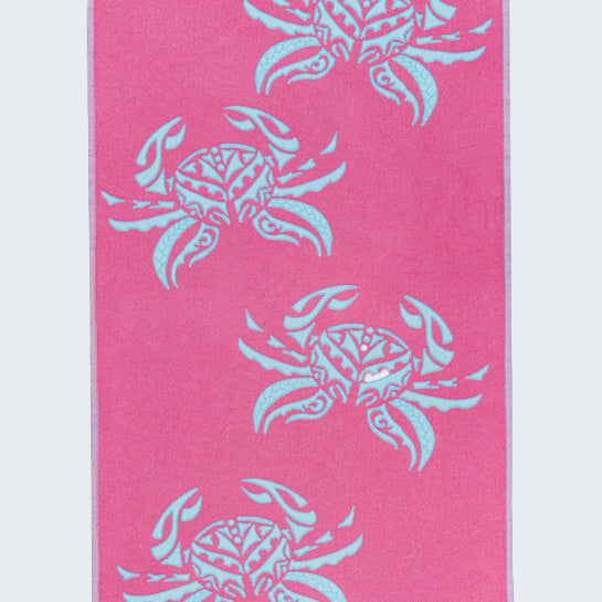 Pink towel with blue crab patterns on a white background