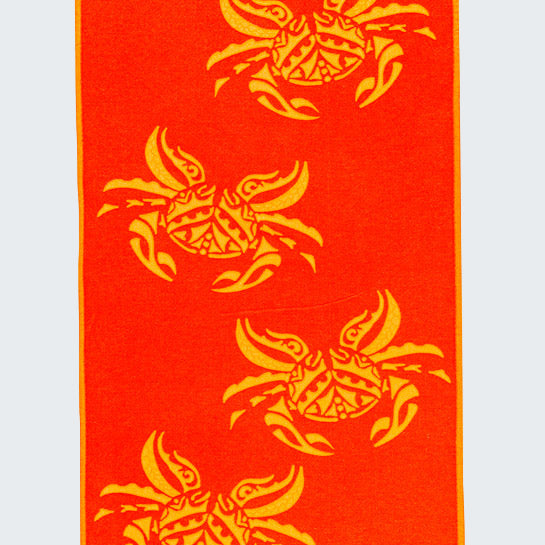 Red towel with yellow fish patterns on a white background